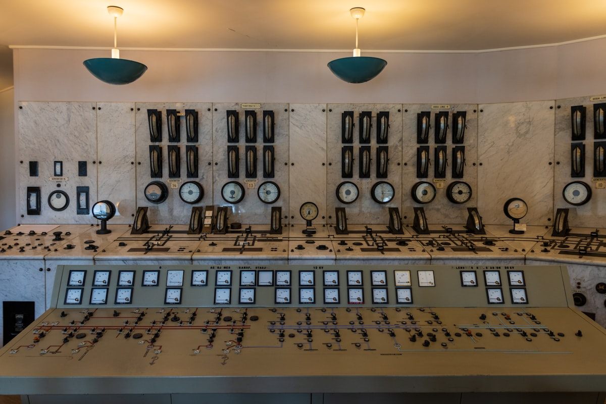 Industrial control room with analog gauges switches and control panels